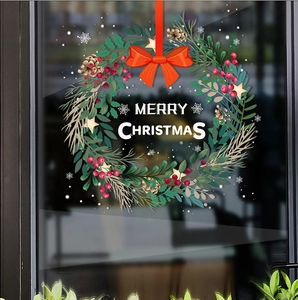 Detail of Christmas wreath static window sticker with Merry Christmas text and red bow