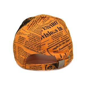 Rear view of orange newspaper print baseball cap with adjustable silver metal buckle