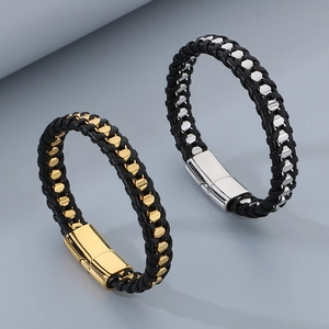 Close-up of woven black leather bracelet with polished stainless steel magnetic clasp