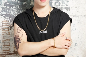 Close-up of a man wearing a bold gold Cuban link necklace and bracelet set in street style
