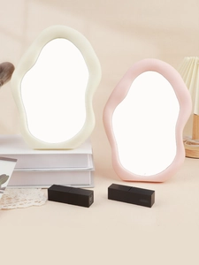 Irregular cloud-shaped makeup mirrors in cream white and soft pink on a vanity desk
