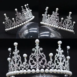 Detail view of silver bridal crown featuring white pearls and sparkling rhinestones