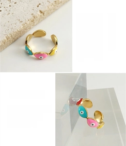 Detailed view of 18K gold plated stainless steel evil eye rings with colorful enamel