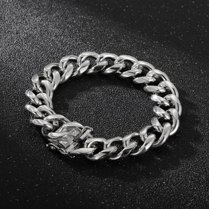 Bracelet gourmette en acier inoxydable argenté poli sur une surface noire texturée