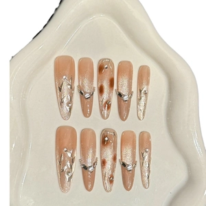 Brown cat eye press-on nails in long almond shape with silver 3D lines and rhinestones