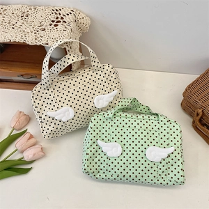 Polka dot travel toiletry bag with plush 3D wing detail in cream and mint colors
