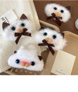 Detailed view of plush Siamese cat hair claws with soft faux fur and cute ribbon bows
