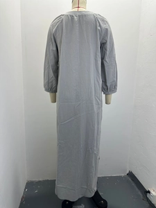 Back view of a casual grey long sleeve linen maxi dress on a mannequin with round neck