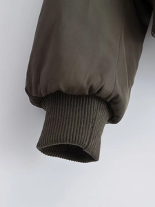 Detail view of olive green bomber jacket with windproof elastic ribbed knit cuffs