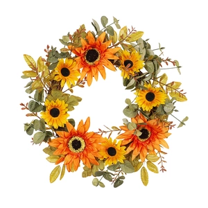 Autumn artificial sunflower wreath with yellow flowers and green leaves on rattan ring
