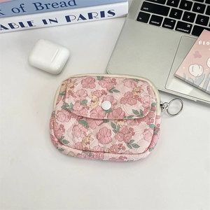 Detailed close-up of pink quilted floral pouch with bunny prints and snap button closure