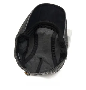 Detail view of cotton flat cap interior showing sweatband and adjustable metal buckle