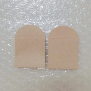 Close-up of small kraft paper pouches with arch-shaped tops on bubble wrap background