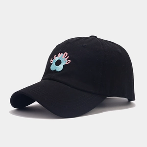 Detailed embroidery of light blue flower and pink STUDIO text on black cotton baseball cap