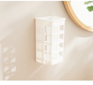 White wall-mounted hair curler holder with hollow design in a cozy bathroom setting