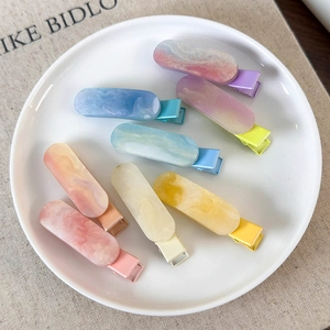 Colorful marble textured oval duckbill hair clips set in a stylish pastel candy color range