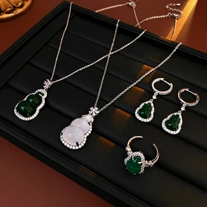 Detailed set of silver necklaces and rings featuring green and white gourd-shaped stones