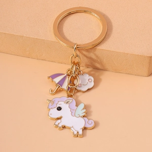 Unicorn keychain with rainbow wings, purple umbrella and smiling cloud pendant charms