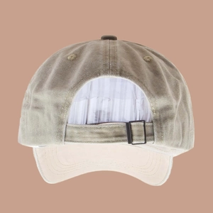 Detail view of washed cotton baseball cap with adjustable metal buckle and vintage texture