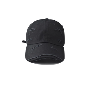 Distressed black cotton canvas baseball cap with vintage frayed holes and retro street style