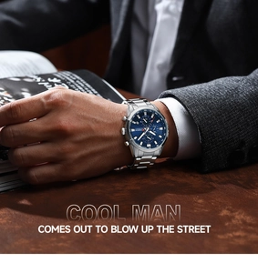 Detail of silver steel business watch with blue dial and chronograph on man's wrist