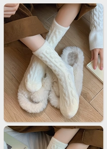 Close-up of cream knit cable socks and plush faux fur home slippers for winter warmth