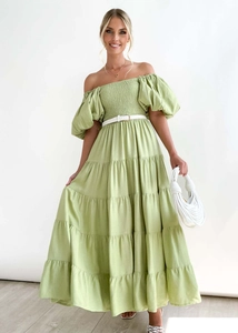 Detail of light green off-shoulder tiered maxi dress with puff sleeves and cotton texture