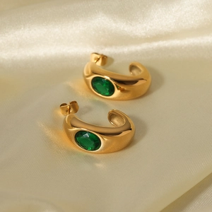 18K gold plated stainless steel C-shaped earrings with green zircon on golden silk fabric