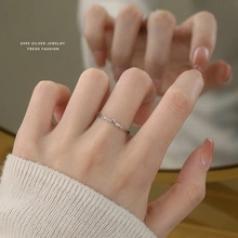 Macro shot of minimalist S925 sterling silver ring worn on hand with mirror reflection