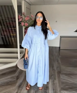 Detail of light blue loose linen maxi shirt dress with long puff sleeves and buttons