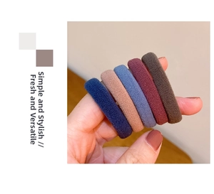 Detailed view of five high-elastic ribbed hair ties in navy, pink, blue, red, and brown