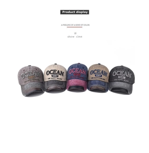 Front view of five assorted distressed cotton baseball caps with Ocean embroidery
