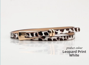 Macro detail of white leopard print skinny belt with a polished gold alloy buckle