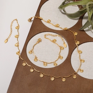 Golden sunburst petal jewelry set with necklace and bracelet in 18K titanium steel