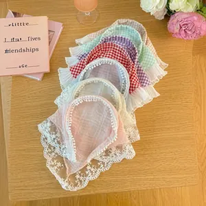 Lace-trimmed Korean style headbands in pastel colors and plaid patterns on wood