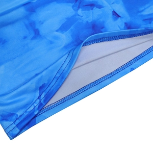 Detailed view of precision stitching and blue tie-dye fabric on a two-piece skirt set