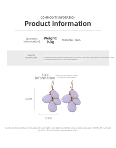 Detailed view of white teardrop tassel earrings with dimensions 5.6cm by 2.3cm