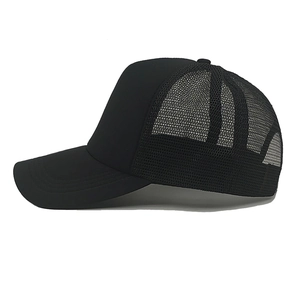 Detailed side view of black breathable mesh panel and solid brim on trucker cap