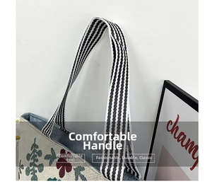Detail of black and white striped handles on vintage floral embroidered tote bag