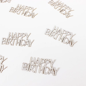 Close-up of sparkling silver Happy Birthday glitter confetti for party table decoration