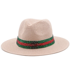Close-up of beige straw fedora featuring red and green rhinestone striped band detail