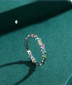 Macro view of sterling silver rainbow ring with colorful zircon stones in bezel settings