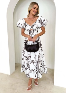 Detail of V-neck knot with cutout on white floral maxi dress with puff sleeves