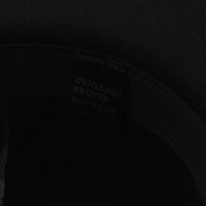 Detail view of the fedora hat label showing 65% cotton and 35% polyester fabric composition