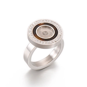 Macro detail of silver stainless steel ring with white zircon border and brown center