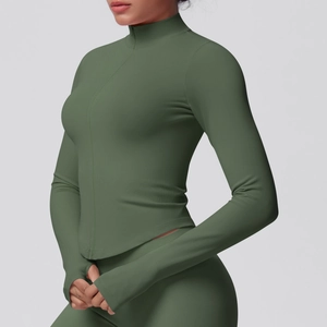 Detailed view of dark green yoga jacket with rib-knit texture and thumbhole cuffs