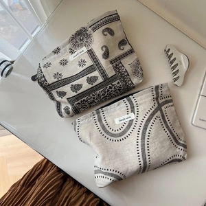 Detail of vintage paisley and dotted pattern cotton linen pouches with zipper closure