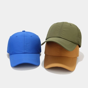 Detail of waterproof breathable baseball caps in blue, green, and yellow quick-dry fabric