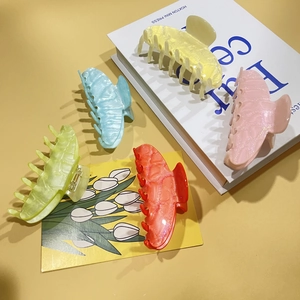 Five colorful glitter acrylic claw clips in pastel shades for elegant hair styling