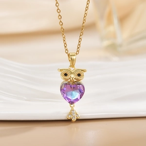 Golden owl necklace featuring a purple heart crystal and micro-pave zircon details